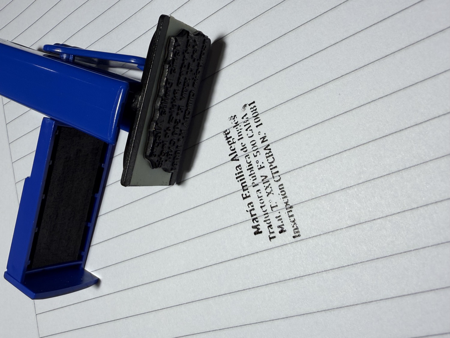 Emilia's professional sworn-translator stamp and its imprint on paper